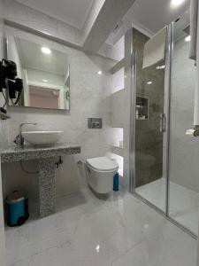 a bathroom with a toilet and a sink and a shower at AZRA SULTAN HOTEL&SPA in Istanbul