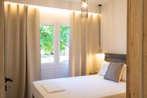 a bedroom with a bed and a window at Elena luxury living in Paralía Skotínis