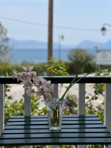 a vase of flowers sitting on a table at Cosy Apartment With Sea View Close To The Beach in Nikiana