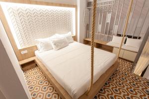a bedroom with a swing bed in a room at aella apartments in Nikiti
