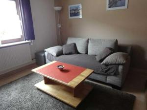 a living room with a couch and a coffee table at Ferienwohnung Hilde Schneider in Kappeln