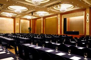 a conference room with tables and chairs and chandeliers at Lotte Hotel Seoul in Seoul