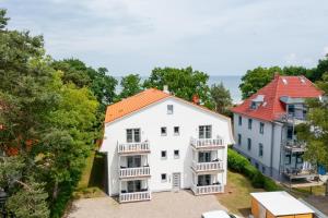 an aerial view of a white house with an orange roof at Strandvilla Meeresblick Wohnung 07 in Boltenhagen