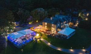 an aerial view of a house at night with lights at Aberdunant Hall in Porthmadog