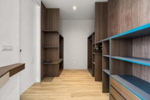 a walk in closet with wooden shelves at Lumi Tropicana in Petaling Jaya