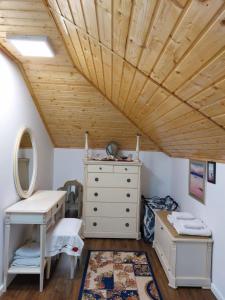 a bedroom with a wooden ceiling and a dresser at Verada Tour Guest House in Somova