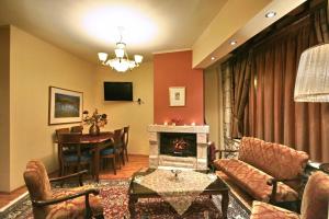 a living room with a couch and a fireplace at Guesthouse Stemnitsa in Stemnitsa