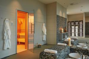 a bathroom with two sinks and a shower at HYPERION Hotel Hamburg City, Trademark Collection by Wyndham in Hamburg