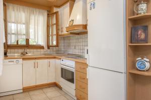 a kitchen with white appliances and a white refrigerator at VILLA PALMERA in Ierissos