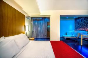 a hotel room with a bed and a living room at Capsis Hotel Thessaloniki in Thessaloniki