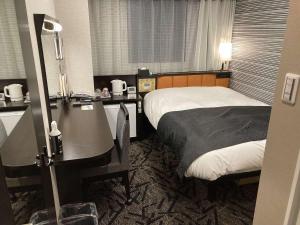 Katil atau katil-katil dalam bilik di APA Hotel Beppu Ekimae