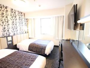 Postelja oz. postelje v sobi nastanitve APA Hotel Beppu Ekimae