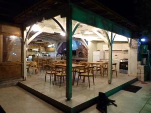 a dining room with wooden tables and chairs at Makis Nest Apart-Hotel in Vourvourou