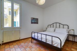 a bedroom with a bed and a window at Castiglione Family Apartment by Wonderful Italy in Bologna