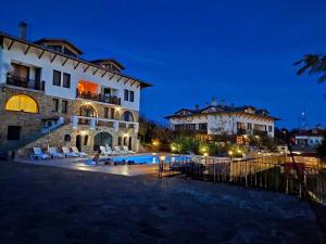 a large building with a swimming pool in front of it at Hotel Winpalace in Arbanasi