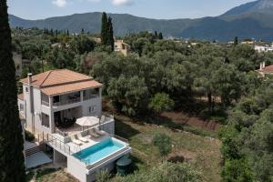 an aerial view of a house with a swimming pool at Villa Mythos with Infinity Pool in Dassia