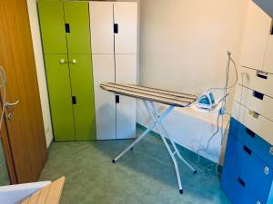 a room with a desk and green and white cabinets at Casa Al Piazzol in Alano di Piave