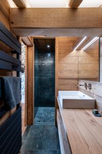 a bathroom with a sink and a shower at Aigle des Neiges 5 étoiles in Gérardmer