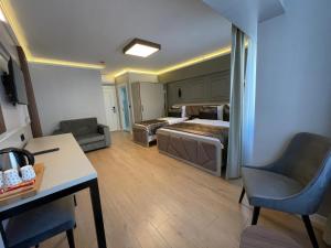 a hotel room with two beds and a desk at AZRA SULTAN HOTEL&SPA in Istanbul