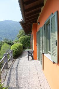 a balcony of a house with a table and a bench at Appartamenti Ferrari Residence in Cannobio