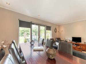 a dining room with a long table and chairs at Holiday Home in Garderen with Garden in Garderen +32 photos