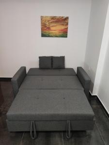 a bed sitting in a room next to a wall at THEASIS 4 luxury studio with sea view in Neos Marmaras