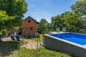 a pool with a swing and a house at House Nado in Pulgarija Čepić +27 photos