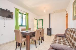 a dining room with a table and chairs at House Oliver in Dobropoljana