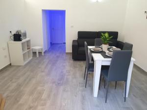 a living room with a table and a couch at La Perla di Ele in Bari