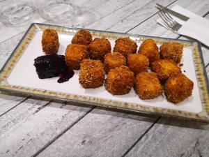 a plate of food with meatballs on a table at Hotel Aro'S in Casas Ibáñez +46 photos