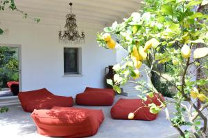 a room with red pillows and a tree at HMO Glamping & Suites in Vignanotica in Mattinata
