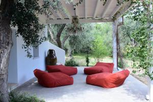 a group of red pillows sitting on a patio at HMO Glamping & Suites in Vignanotica in Mattinata