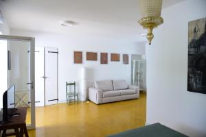 a living room with a white couch and a table at HMO Glamping & Suites in Vignanotica in Mattinata