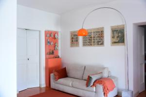 a living room with a couch and an orange lamp at HMO Glamping & Suites in Vignanotica in Mattinata