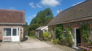 a couple of houses with ivy growing on them at Newditch Farm Accommodation in Bristol