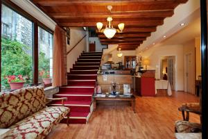 a living room with a staircase and a couch at Guesthouse Stemnitsa in Stemnitsa