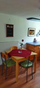 a table and chairs with a vase with a flower on it at Casa Servatius in Briedel