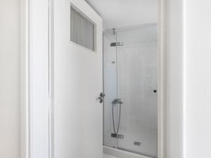a shower with a glass door in a bathroom at Modern Penthouse overlooking Halkis in Chalkida