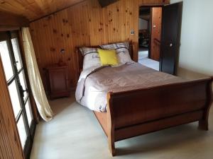a bedroom with a bed with a yellow pillow on it at LA BOULZANE in Puilaurens