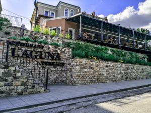 a brick retaining wall with a building on top of it at Hotel Laguna Terrace in Kavarna