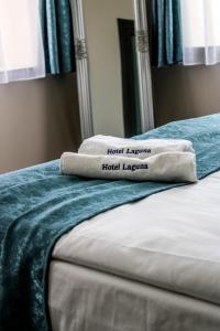 a pair of towels sitting on top of a bed at Hotel Laguna Terrace in Kavarna