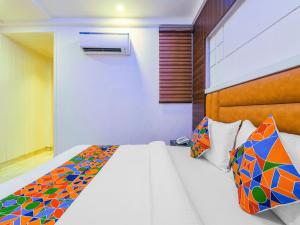1 dormitorio con 1 cama con una almohada estampada colorida en The Mohit Guest House - New Delhi Railway Station - Paharganj, en Nueva Delhi