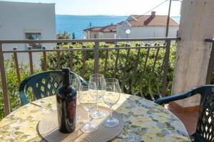 a table with glasses and a bottle of beer on it at Family Holiday house - 50 m to the beach! in Kožino