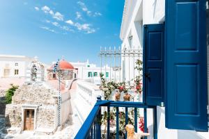 a blue door on a balcony with a view of a street at Ryous Mykonos in Mikonos