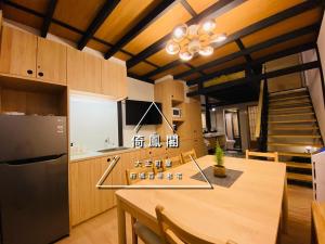 a kitchen with a large wooden table and a staircase at 倚鳳閣 in Tainan