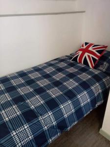 a bed with two pillows on top of it at Picturesque holiday cottage Britanny France in Treuscoat