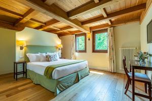 a bedroom with a large bed and a wooden ceiling at Fiori e Frutti Agriresort in Mestre