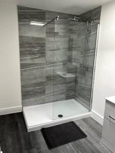 a shower with a glass door in a bathroom at Quay33 Deluxe Apartment, Barbican, Plymouth in Plymouth