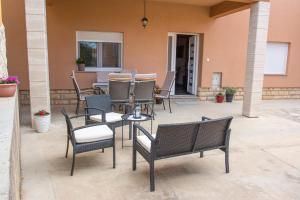 a group of chairs and a table on a patio at Apartman Joso in Sukošan