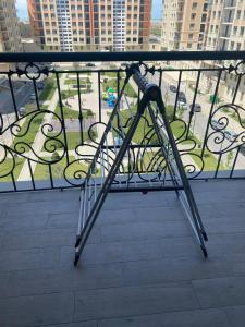 a metal railing on a balcony with a view of a city at Seaside Luxury Apartment in Sumqayıt